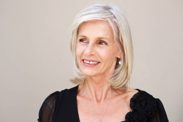 istock smiling older woman thinking in black blouse 872772586