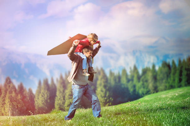 istock Little Boy Flying in a Cardboard Plane 872773382
