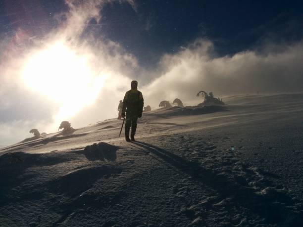 istock hiking in extreme windy conditions in mountains 872776076