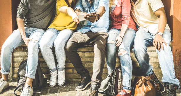 istock Group of multiculture friends using smartphone on urban background - Technology addiction concept in youth lifestyle disinterested to each other - Always connected people on modern mobile smart phones 872776310