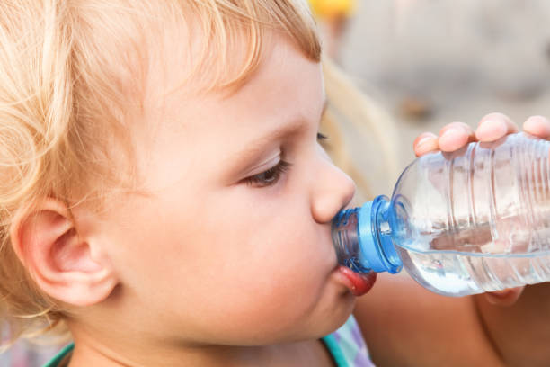 istock Caucasian child drink water from plastic bottle 872777746