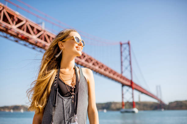 woman near the bridge in lisbon, portugal - portugal turismo imagens e fotografias de stock