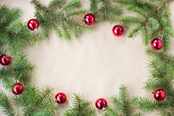 istock Fir tree branches decorated with red christmas balls as border on a rustic holiday background frame with copy space 872782660