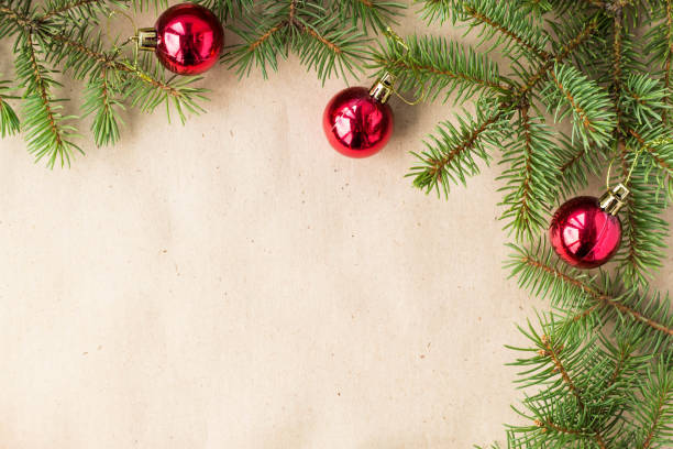 istock Fir tree branches decorated with red christmas balls as border on a rustic holiday background frame with copy space 872782760