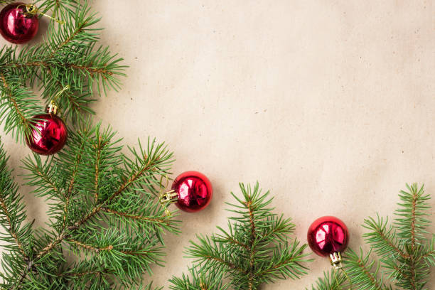 istock Fir tree branches decorated with red christmas balls as border on a rustic holiday background frame with copy space 872782780