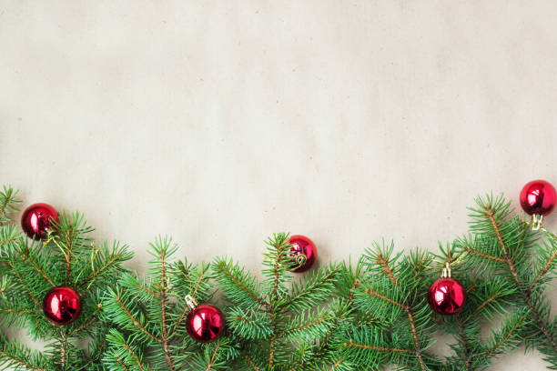 istock Fir tree branches decorated with red christmas balls as border on a rustic holiday background frame with copy space 872782810