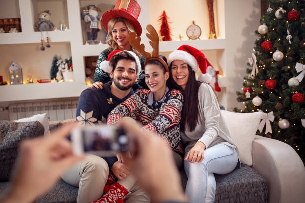 istock photographing friends by phone for Christmas 872786334