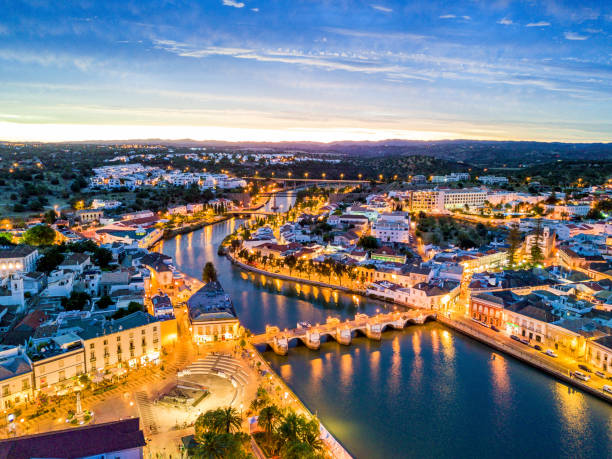 Beautiful Tavira by Gilao river, Algarve, Portugal Moorish historic town of Tavira by Gilao river, Algarve, Portugal faro district portugal photos stock pictures, royalty-free photos & images