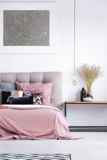 istock Cozy bedroom with pastel bedclothes 872787266