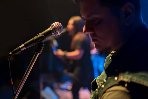istock Singer in front of a microphone 872787302