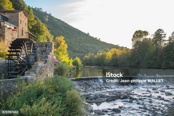 Beautiful And Colorful River Mountain Autumn Fall Season Landscape With A Watermill At Sunset Stock Photo - Download Image Now