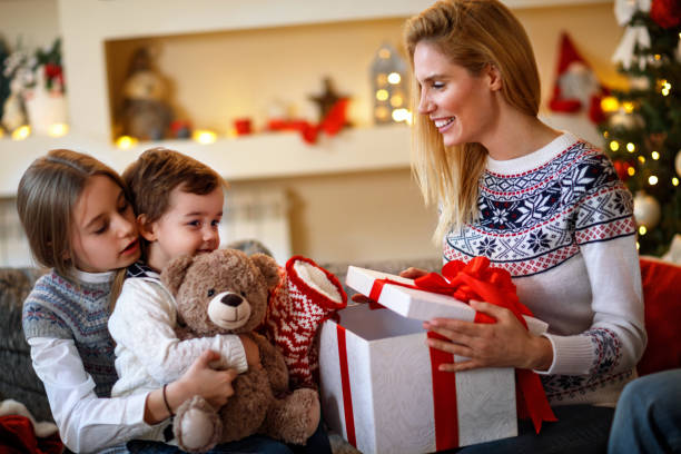 istock Cheerful children looking Christmas gifts 872789942