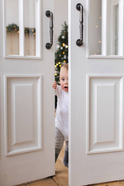 istock Charming kid opens the door and is surprised 872790782
