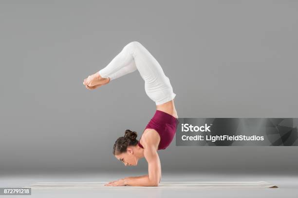 Woman Doing Yoga Exercise Stock Photo - Download Image Now - Headstand, Women, Yoga