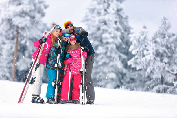 istock Family together skiing on mountain 872798086