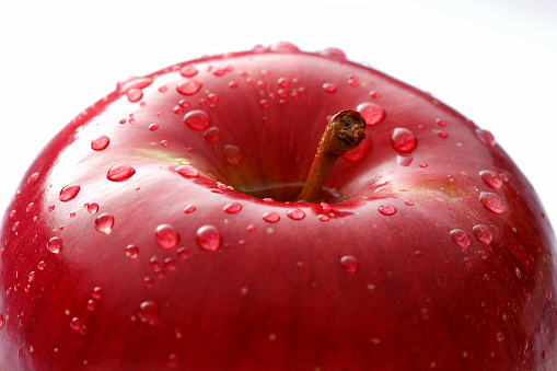 Close-up of water droplets on a fresh apple ; shot with very shallow depth of field