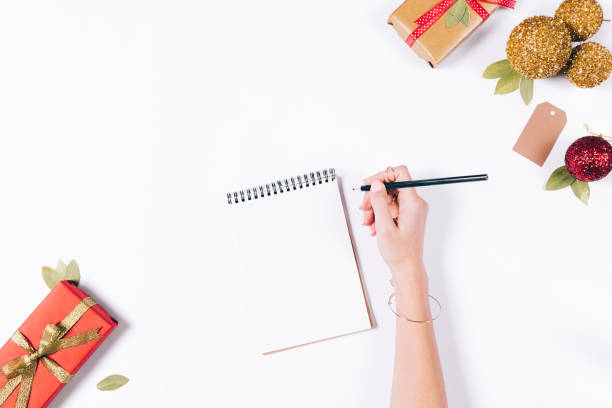 istock Female hand writes in a notebook with a pencil 872799252