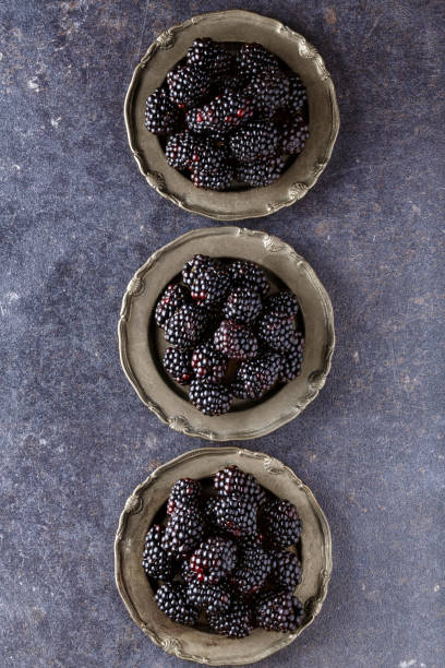istock top view on raw blackberries in plate on dark table background 872799778
