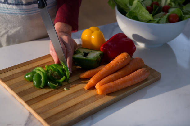 istock Mid section of woman chopping vegetables 872805886