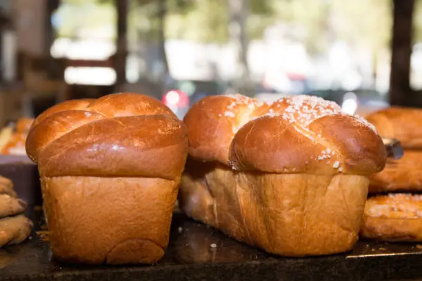 food background: fresh sweet brioche for Breakfast. Close-up.