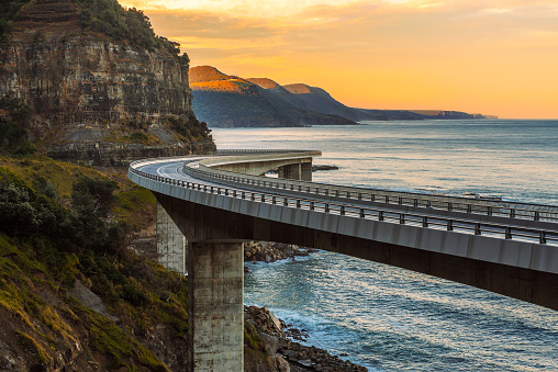 Sunset over the Sea cliff bridge along Australian Pacific ocean coast near Sydney, Australia.