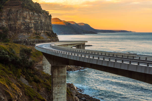 Sunset over the Sea cliff bridge along Australian Pacific ocean stock photo