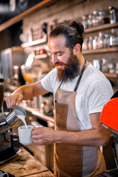 istock Barista pouring milk for makking latte 872810058