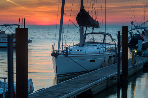istock Sailboat at jetty in marina at dawn 872813826