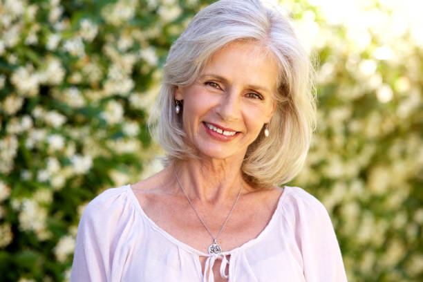 istock happy older woman standing in garden 872814628