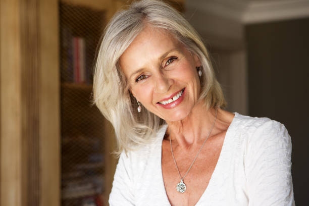 istock beautiful older woman standing in study smiling 872814666