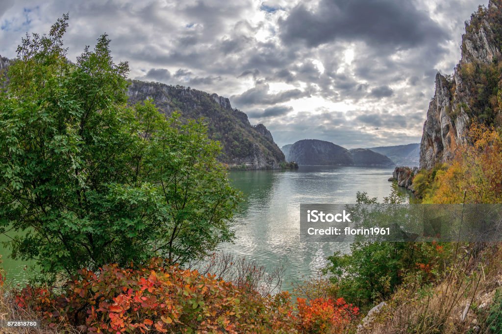 Autumn at the Danube Gorges, border between Romania and Serbia Autumn at the Danube Gorges, the border between Romania and Serbia. View from Serbian part. In the background is strait named Large Boilers. Danube River Stock Photo