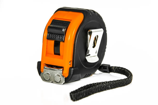istock Single orange and black tape measure, isolated over white 872821828