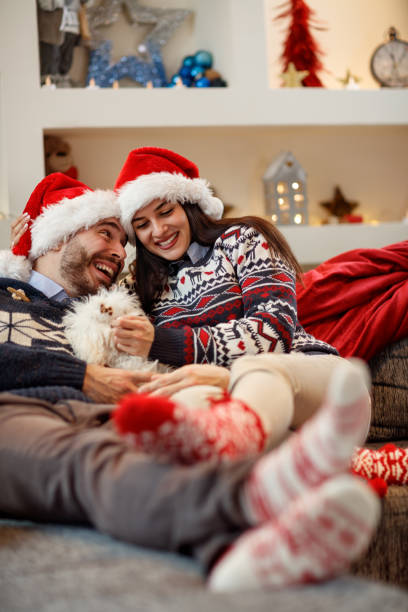 istock Pair in Christmas night enjoying in bad with their dog 872821936