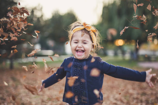 istock Leaves everywhere , little girl is happy 872825432