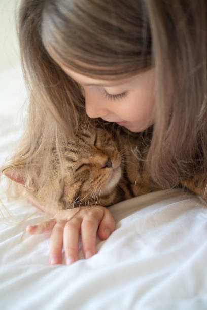 istock Little girl with cat 872828560