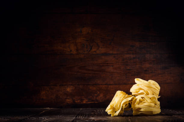 Uncooked pasta composed on wood