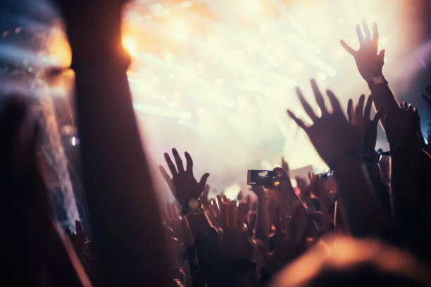 istock Cheering crowd at concert enjoying music performance 872832532