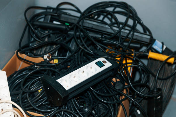 istock Mess of electrical cables with Surge protector on top of it 872832598