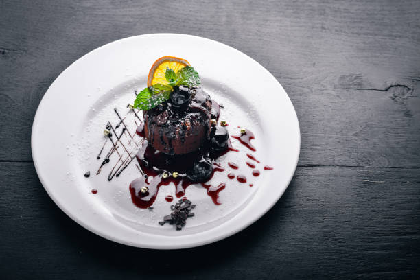 istock Chocolate dessert. Baking with ice cream. Top view. Free space for text. On a wooden background. 872833360