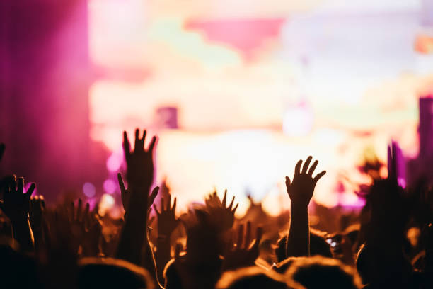 istock Cheering crowd at concert enjoying music performance 872833522