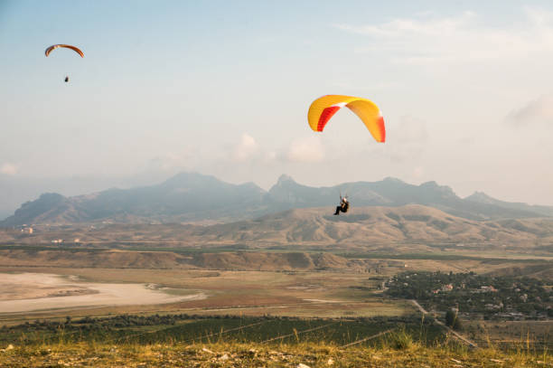 istock people flying on paragliders sky 872833526