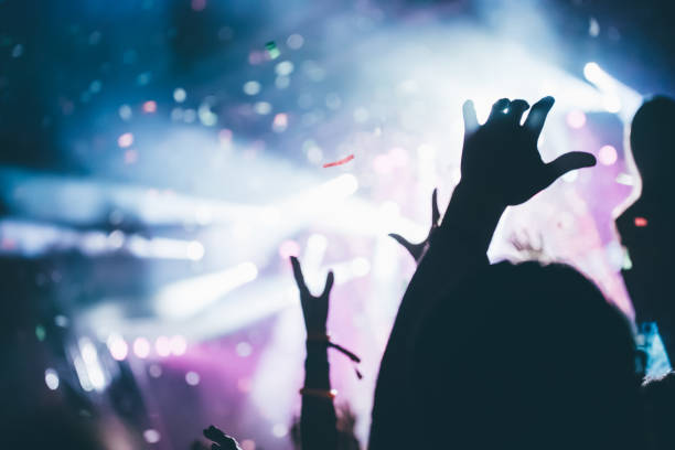 istock Cheering crowd at concert enjoying music performance 872833728