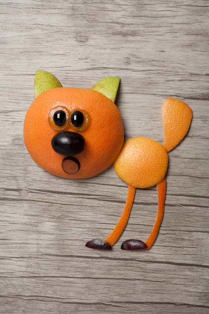 istock Cat made with orange on wooden background 872834312