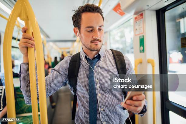 Businessman Commuting By Tram In Melbourne Stock Photo - Download Image Now - Bus, Men, Australia