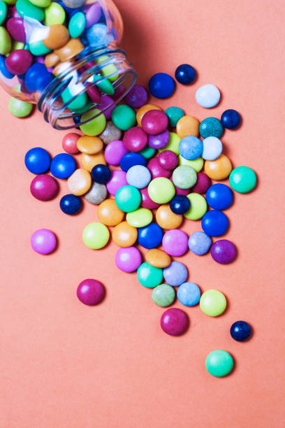 istock Glass jar and heap colorful candy 872840072