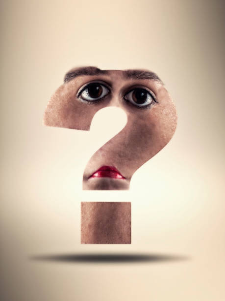 istock Question mark with texture of human face 872840240