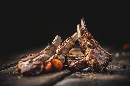 Grilled lamb chops on wooden table