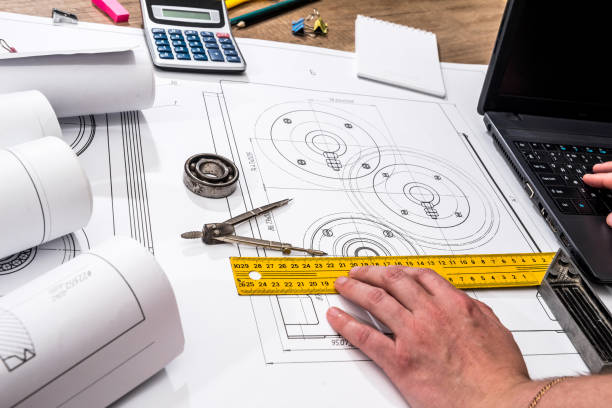 istock mechanical engineering of parts with tools, laptop, drawing top 872840956