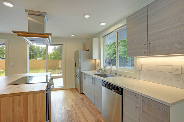 istock Newly remodeled kitchen boasts kitchen island with a hood. 872845240