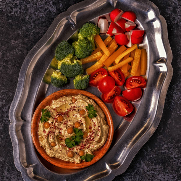 istock Classic hummus with vegetables on the plate and pita bread. 872849844